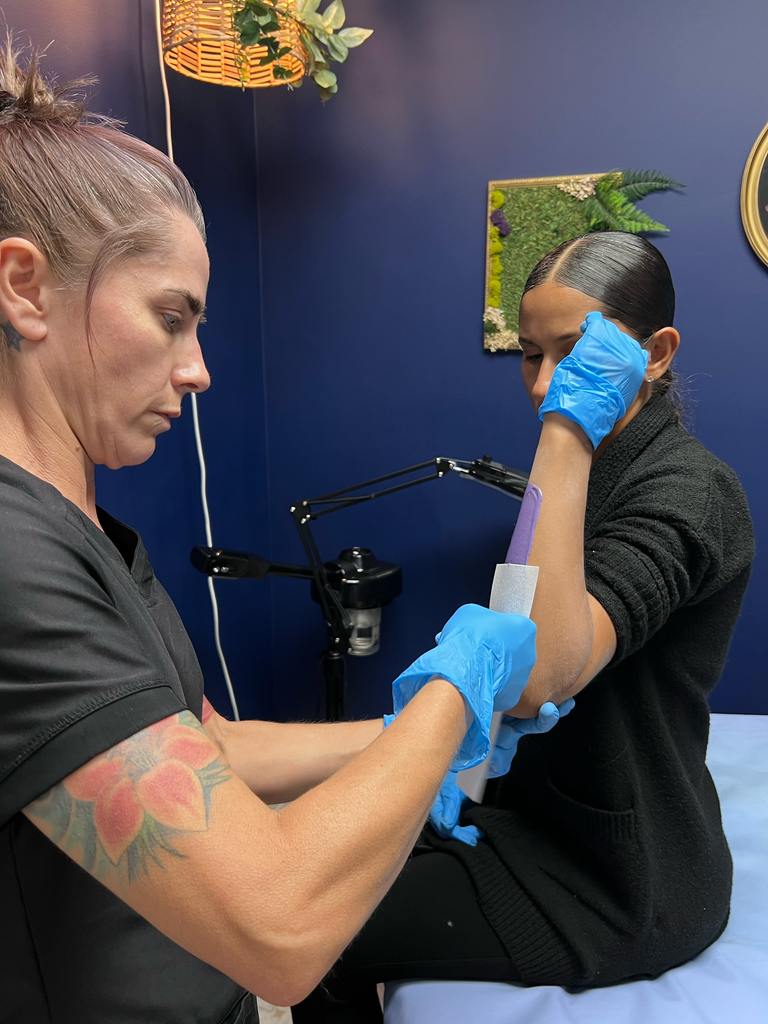 chyrstal waxing a womans arm
